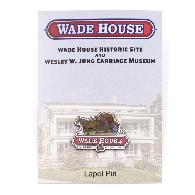 Lapel pin shaped as the Wade House historic site logo. The top half of the logo is a man driving a carriage driven by two horses talking to a man and women dressed in old-fashioned clothing. Under that image is the site name "Wade House" in a red banner, and "A Wisconsin Historic Site" underneath.