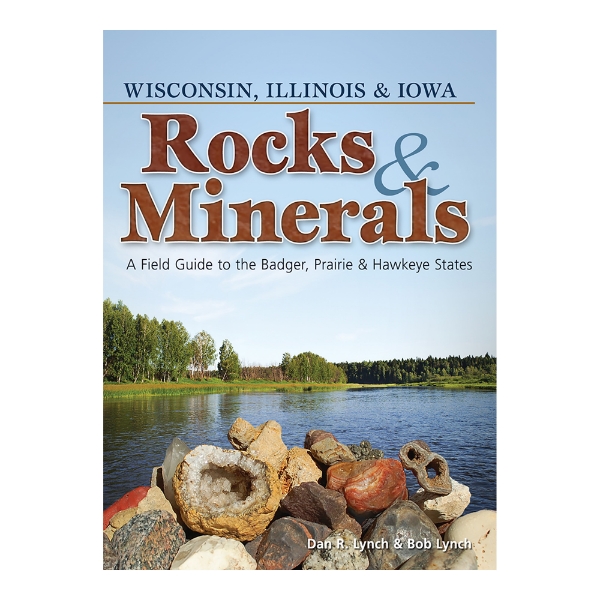 Rocks & Minerals book cover featuring a lake with fascinating rocks stacked in the front. Green trees behind the lake with a light blue sky. 