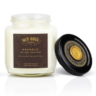 Krampus Candle in clear glass jar with black cover and brown labeling with gold lettering on top of cover and on label. 