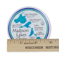 Round magnet showing Madison Wisconsin's chain of lakes. Blue lakes on white background. Ruler shows 3-inch diameter.