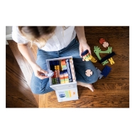 Interlocking architectural block set from Lowercase Toys. Overhead view of open box held by child.