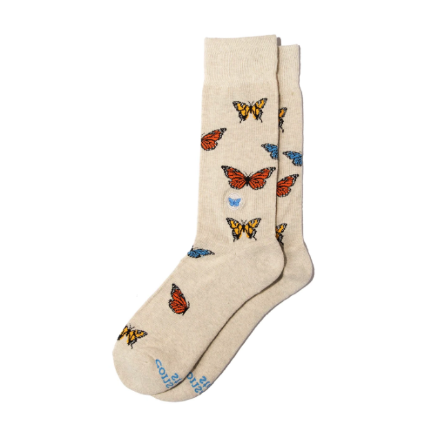 Two tan socks with colorful butterfly motif.