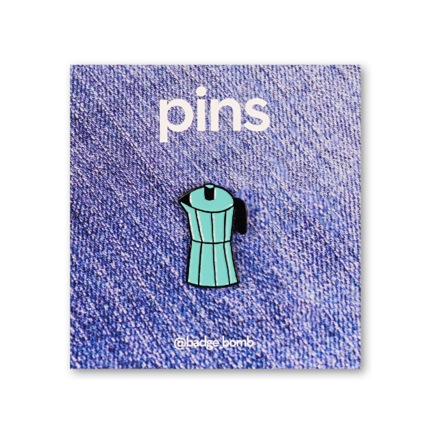 An enamel pin of a teal coffee percolator 